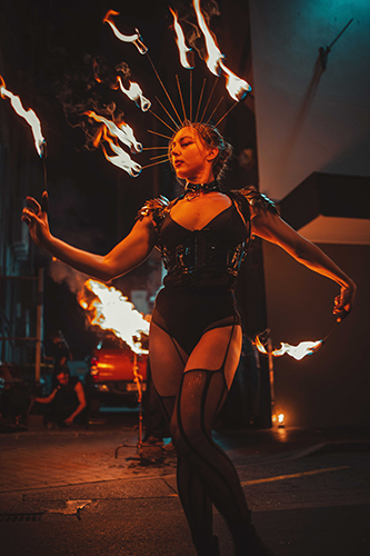 Performer Felicity Boyd of Motus Collective. Performing with Fire Crown and Fire Fingers. Fire performance at UNSEEN Winter Solstice Fire Festival 2023, event by Dragon Mill, Light Square, Adelaide, photo by Castleforge Photography
