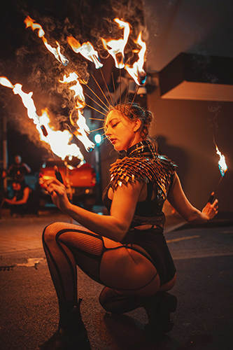 Performer Felicity Boyd of Motus Collective. Performing with Fire Crown and Fire Fingers. Fire performance at UNSEEN Winter Solstice Fire Festival 2023, event by Dragon Mill, Light Square, Adelaide, photo by Castleforge Photography